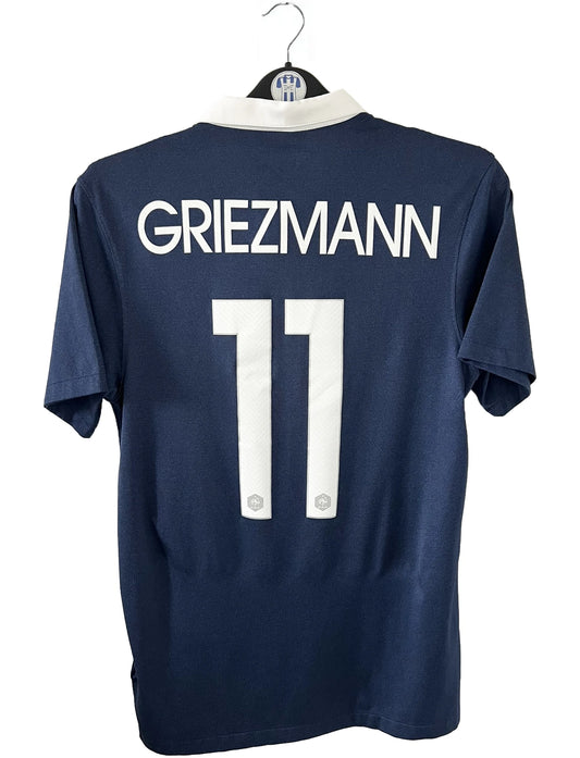 Maillot foot vintage domicile de l'équipe de france 2014. On peut retrouver l'équipementier nike. Le maillot est floqué du numéro 11 Antoine Griezmann. Il s'agit d'un maillot authentique d'époque comportant l'étiquette 577926-410