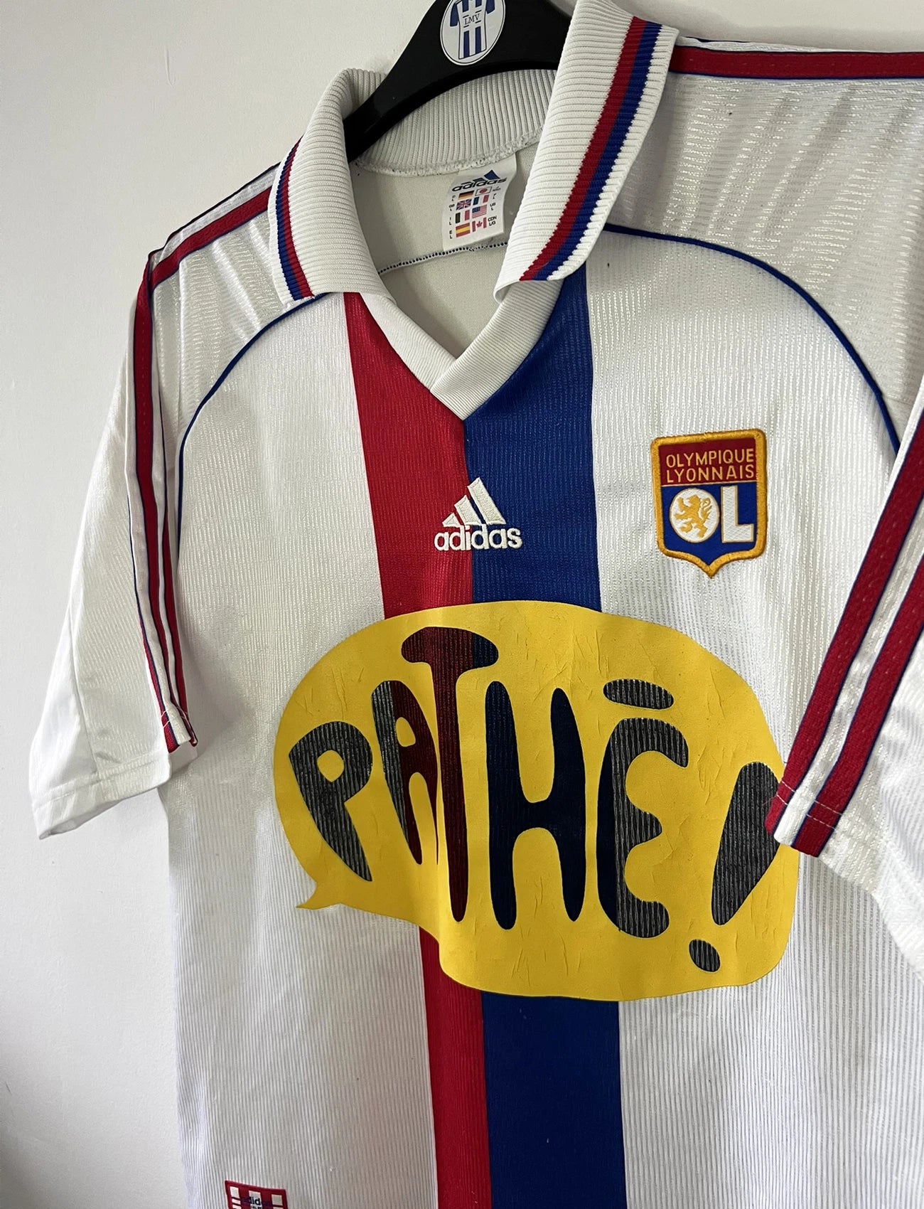 Maillot de foot vintage domicile blanc de l'OL de la saison 1999/2000. On peut retrouver l'équipementier adidas et le sponsor pathé. Le maillot est floqué du numéro 9 Sonny Anderson. Il s'agit d'un maillot authentique d'époque.