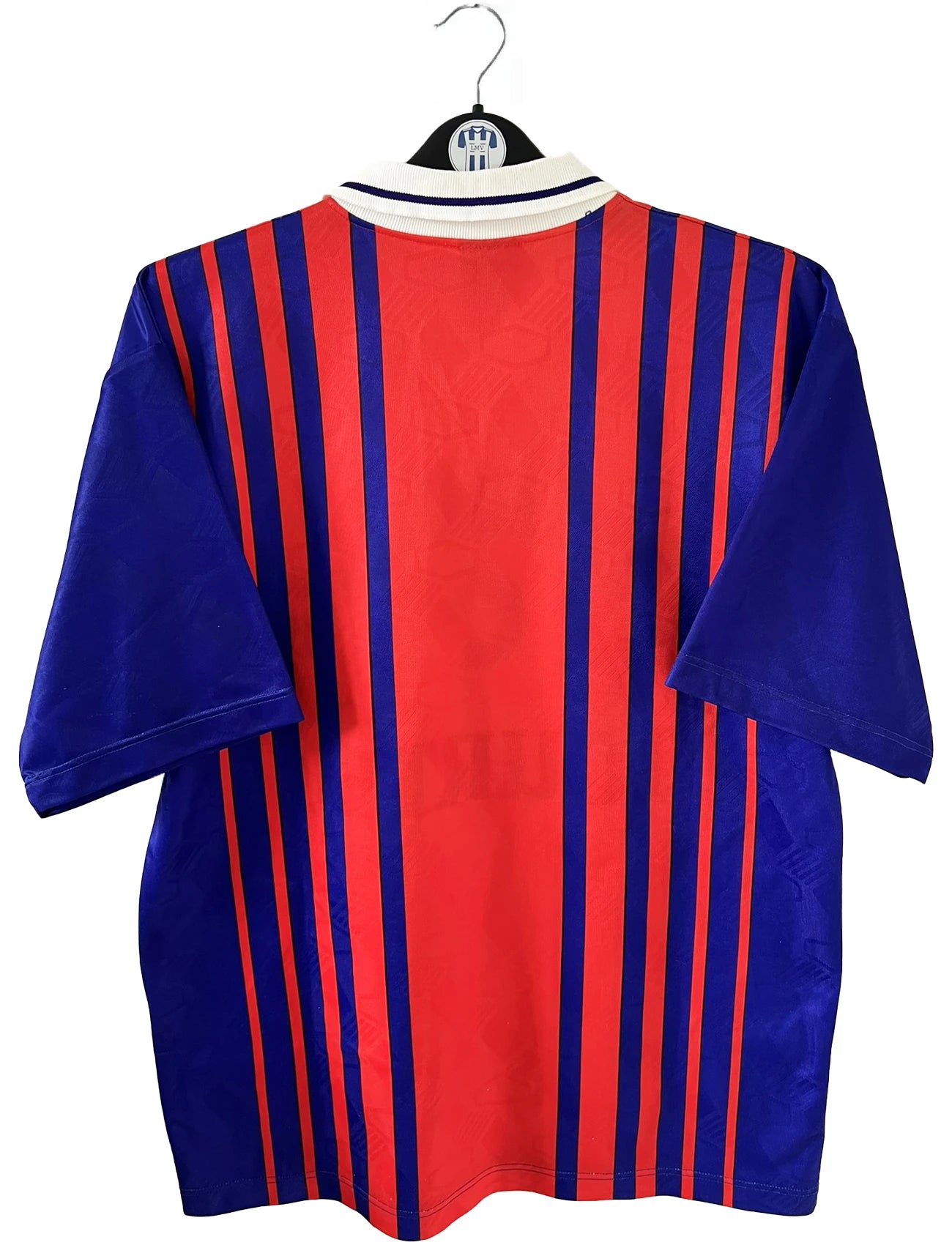 Maillot vintage domicile rouge et bleu du PSG de la saison 1993/1994. On peut retrouver l'équipementier nike, le sponsor commodore et le sponsor tourtel