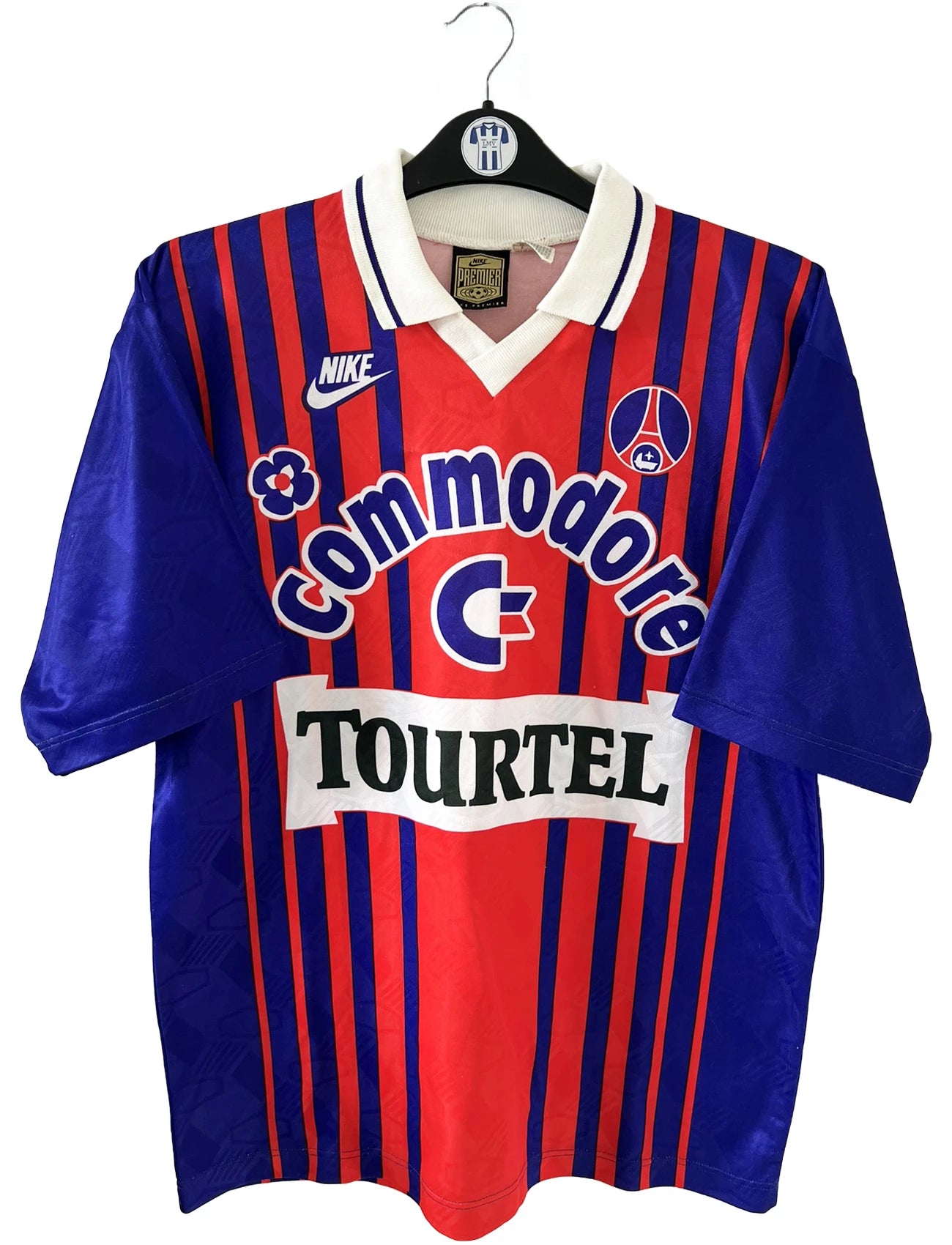 Maillot vintage domicile rouge et bleu du PSG de la saison 1993/1994. On peut retrouver l'équipementier nike, le sponsor commodore et le sponsor tourtel